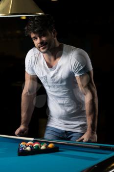 Portrait Of A Young Man Concentration On Ball In Pool Game Billiard