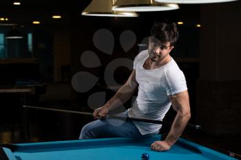 Portrait Of A Young Man Playing Billiards Pool Game