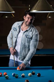 Portrait Of A Young Man Concentration On Ball In Pool Game Billiard