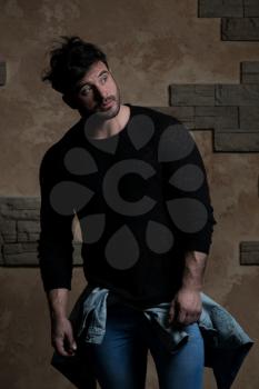 Portrait of Handsome Bearded Man Dressed in Fashionable Clothes Standing Against Wall Background With Area for Advertising Content - Hipster Guy Posing on Copy Space