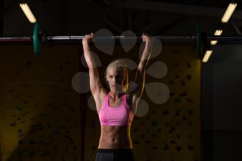 Young Woman Performing Barbell Shoulder Workout - One Of The Best Bodybuilding Exercise For Shoulders