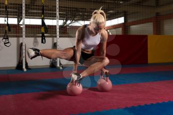 Young Woman Exercising With Kettle Bell And Flexing Muscles - Muscular Athletic Bodybuilder Fitness Model Exercises