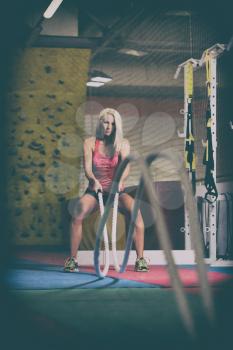Battling Ropes Young Woman At Gym Workout Exercise