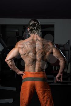 Healthy Mature Tattoo Man Standing Strong In The Gym And Flexing Muscles - Muscular Athletic Bodybuilder Fitness Model Posing After Exercises