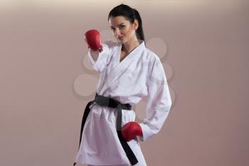Young Woman Practicing Her Karate Moves - White Kimono - Black Belt