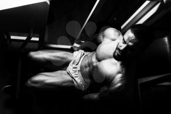 Man Exercising Leg With Machine In Gym - Leg Exercises Close Up