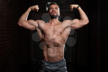 Portrait of a Young Physically Fit Model Showing His Well Trained Body - Muscular Athletic Bodybuilder Fitness Man Posing After Exercises