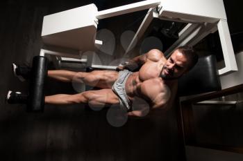 Man Exercising Leg With Machine In Gym - Leg Exercises Close Up