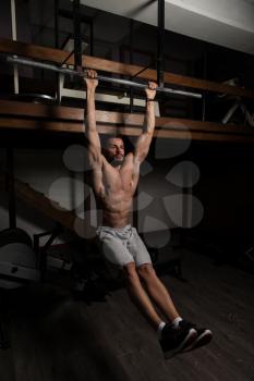 Model Performing Hanging Leg Raises Exercise - One Of The Most Effective Ab Exercises