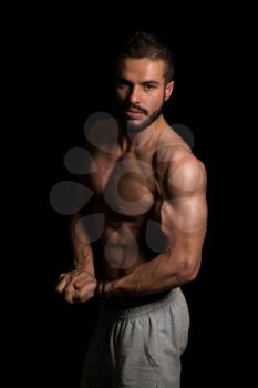 Young Model Flexing Muscles - Isolate On Black Blackground - Copy Space