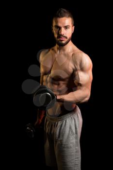 Muscular Model Doing Heavy Weight Exercise For Biceps With Dumbbells On Black Background