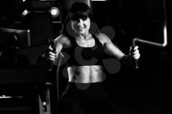 Fitness Woman Doing Heavy Weight Exercise For Chest On Machine With Cable In The Gym
