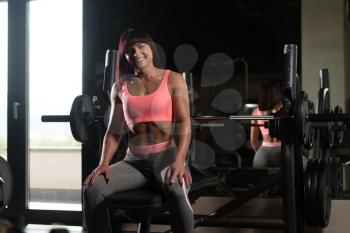 Attractive Woman Resting On Bench After Exercise In Fitness Center