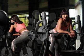 Attractive Woman Resting On Bench After Exercise In Fitness Center
