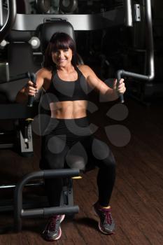 Fitness Woman Doing Heavy Weight Exercise For Chest On Machine With Cable In The Gym