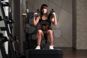 Attractive Woman Doing Leg With Machine In Gym - Leg Exercises