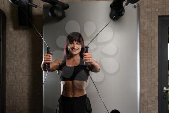 Young Woman Is Working On Her Chest With Cable Crossover In A Modern Fitness Gym