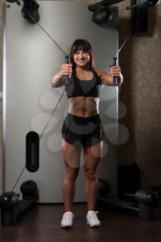 Young Woman Is Working On Her Chest With Cable Crossover In A Modern Fitness Gym