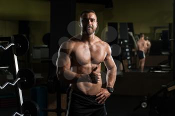 Healthy Young Man Standing Strong In The Gym And Showing Thumbs Up - Muscular Athletic Bodybuilder Fitness Model Posing After Exercises
