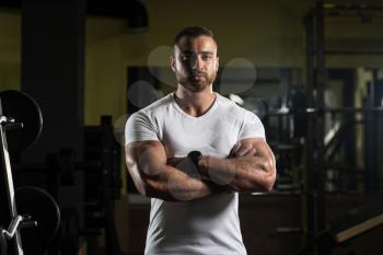 Portrait Of A Young Physically Fit Man Showing His Well Trained Body In White Shirt - Muscular Athletic Bodybuilder Fitness Model Posing After Exercises