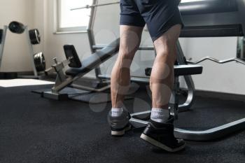 Close Up Of A Bodybuilder Doing Heavy Weight Exercise For Legs Calves