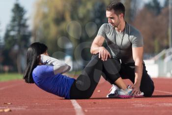 Attractive Couple Exercising in City Park Area - Training and Exercising for Endurance - Fitness Healthy Lifestyle Concept Outdoor