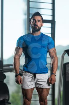 Portrait Of A Young Physically Fit Man In Blue T-shirt Showing His Well Trained Body - Muscular Athletic Bodybuilder Fitness Model Posing After Exercises