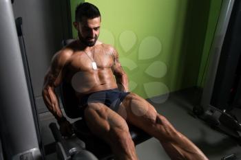 Leg Exercises - Man Doing Leg With Machine In Gym