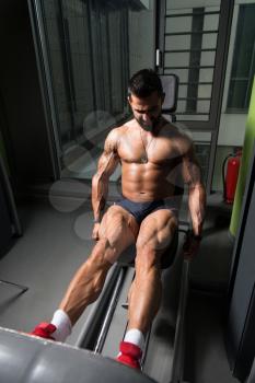 Man Doing Leg With Machine In Gym - Leg Exercises