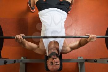 Man In Gym Exercising Chest On The Bench Press