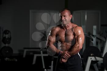 Handsome Mature Man Standing Strong In The Gym And Flexing Muscles - Muscular Athletic Bodybuilder Fitness Male Posing After Exercises