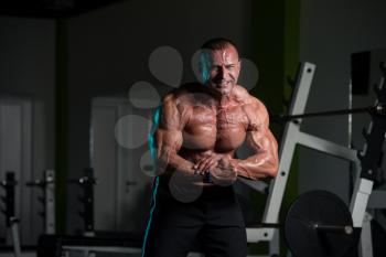 Portrait Of A Mature Physically Fit Man Showing His Well Trained Body - Muscular Athletic Bodybuilder Fitness Male Posing After Exercises