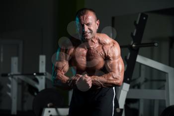 Handsome Mature Man Standing Strong In The Gym And Flexing Muscles - Muscular Athletic Bodybuilder Fitness Male Posing After Exercises