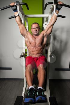 Mature Man Performing Hanging Leg Raises Exercise - One Of The Most Effective Ab Exercises