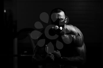 Healthy Young Man Standing Strong  In Elevation Mask And Flexing Muscles - Muscular Athletic Bodybuilder Fitness Model Posing After Exercises
