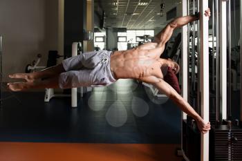 Muscular Man Doing Human Flag Exercise As Part Of Bodybuilding Training In Gym