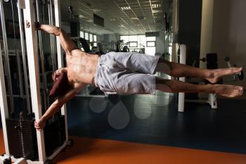 Muscular Man Doing Human Flag Exercise As Part Of Bodybuilding Training In Gym