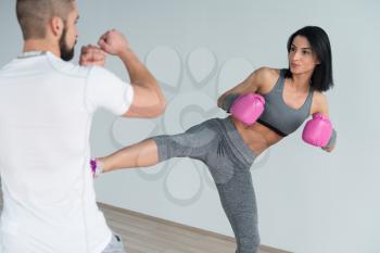 Woman Boxer MMA Fighter Practice Her Skills With Personal Trainer In Gym