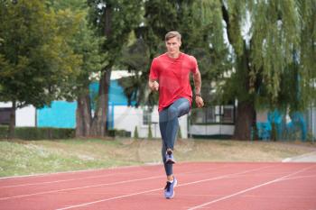 Young Athlete Man Running on Track In Park Run Athletics Race