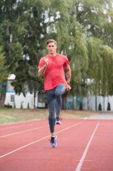 Young Athlete Man Running on Track In Park Run Athletics Race