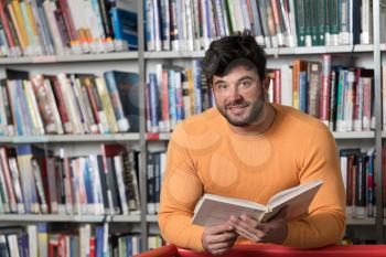 Handsome Man With Dark Hair Standing in the Library - Student Preparing Exam and Learning Lessons in School Library