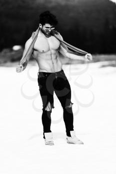 Portrait of a Young Physically Fit Man Showing His Well Trained Body While Wearing Black Jeans - Muscular Athletic Bodybuilder Fitness Model Posing Outdoors - a Place for Your Text