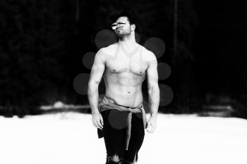Handsome Young Model Standing Strong Outdoors and Flexing Muscles - Muscular Athletic Bodybuilder Man Posing - a Place for Your Text