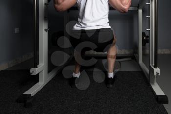 Man Working Out Legs With Barbell In A Gym - Squat Exercise