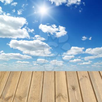 Wooden  floor over a blue sky