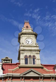 Top of Victoria City Hall and large clock with deep blue sky in background