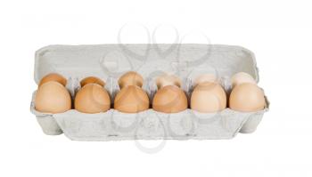 Horizontal photo of a dozen of whole eggs in plain cardboard carton on white background