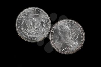 Obverse and Reverse of American Silver Dollar isolated on Black Background