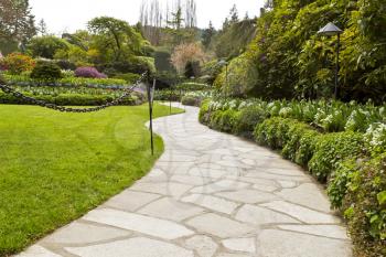 Stone pathway into garden during day time