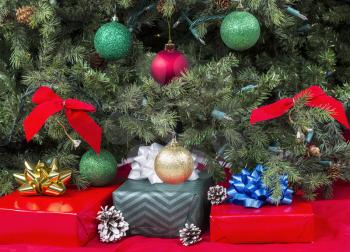Gifts wrapped up for holiday season under decorated tree